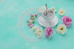 Morning cup of coffee and fresh beautiful pink and white roses flowers ,flat layout, copy space.Coffee drink concept