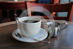 Morning cup of coffee on wood and marble table