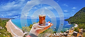 Morning cup of tea with view of colorful panoramic Olympos beach photo