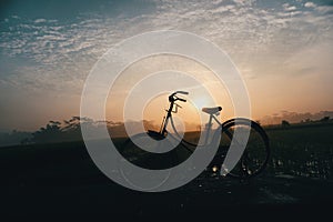 Morning cycling and catching sunrise using old bycycle