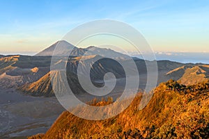 Morning dawn in volcano valley in East Java. Aerial view of volcano and mountains in caldera Bromo. Changing colors every minute