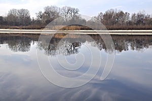 Morning at the Dnieper river with reflactions on still water surface