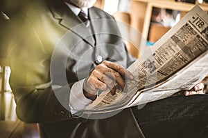 Morning educate. Senior businessmen riding newspaper. Close up i