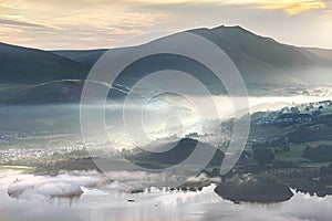 Morning elation as the sunrise illuminates Keswick in the English Lake District with rays of light streaming throught the early mi