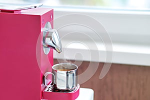 Morning Expresso in a metal cup of capsule coffee machine