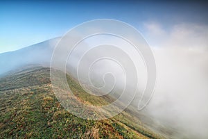 Morning fog around mountaintop