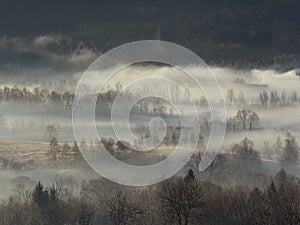 Morning fog in the Central Sudetes. The city of Boguszow-Gorce in the fog. Beautiful landscape of the Stone Mountains at sunrise