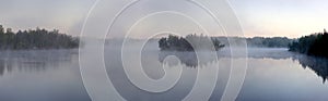 Morning fog on forest lake