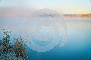 Morning fog on the lake in the frosty morning