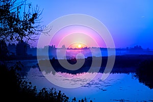 Morning fog on the lake, sunrise shot. Summer or autumn landscape.