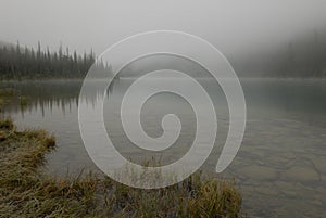 Morning fog over Cavell Lake in Canadian Rockies