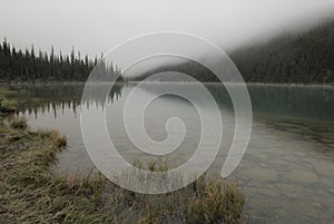 Morning fog over Cavell Lake in Canadian Rockies