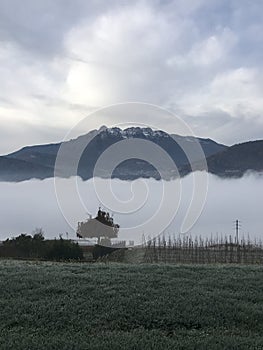 Morning fog over Lake Caldonazzo in Trentino, Northern Italy