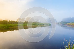 Morning fog over the river curve. Foggy morning landscape