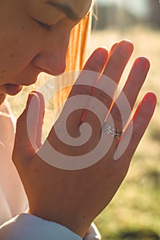 In the morning Girl closed her eyes, praying outdoors, Hands folded in prayer concept for faith, spirituality, religion concept.