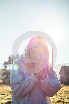 In the morning Girl closed her eyes, praying outdoors, Hands folded in prayer concept for faith, spirituality, religion concept.