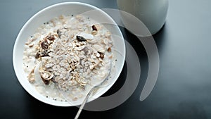 Morning granola breakfast with raisins and almond served with mi