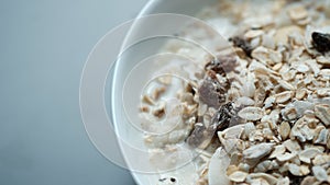 Morning granola breakfast with raisins and almond served with mi