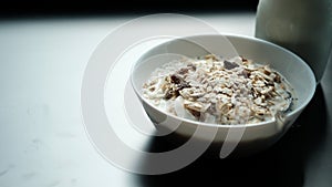 Morning granola breakfast with raisins and almond served with mi