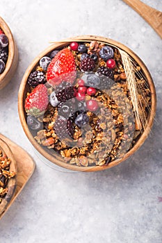 Morning  Granola, Fruits, Berries in bowl on grey concrete background. Healthy breakfast cereals. Concept of dieting, healthy