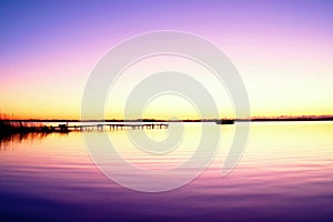 Morning in harbor. Tourists pier above sea. Sunny clear blue sky, smooth water level