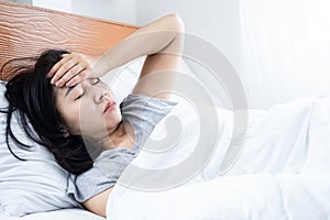 morning headache, dizziness Asian woman wakeup in bed photo