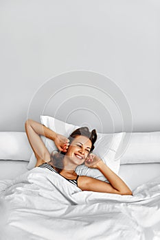 Morning. Healthy Woman After Wake Up Relaxing In Bed. Wellness