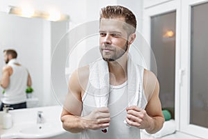 Morning hygiene, Man in the bathroom looking in mirror