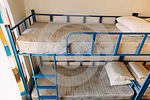 Morning inside the hostel bedroom with clean white beds for students and lonely young tourists