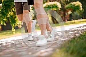 Male legs running along the park path