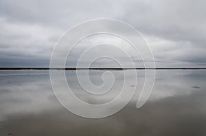 Morning on the lake, the clouds are reflected in the water. Salt Lake Elton, Russia, Volgograd Region.