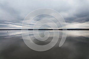 Morning on the lake, the clouds are reflected in the water. Salt Lake Elton, Russia, Volgograd Region.