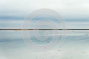 Morning on the lake, the clouds are reflected in the water. Salt Lake Elton, Russia, Volgograd Region.