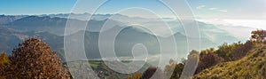 Morning landscape on hills and mountains with humidity in the air and pollution. Panorama from Linzone Mountain