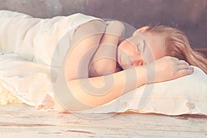 Morning light illuminates woman sleeping in bed photo
