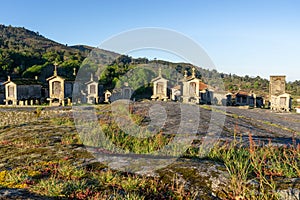 Morning light over granaries and stone storage sheds in the village of Lindoso in Portugal