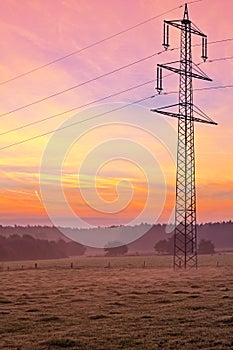 Morning light over the land, power line on a scythed co