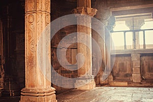 Morning light in window of a sacred Hindu temple in Khajuraho, India. Ancient columns in the 10th century indian temple
