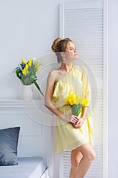 Morning light and woman with yellow tulips