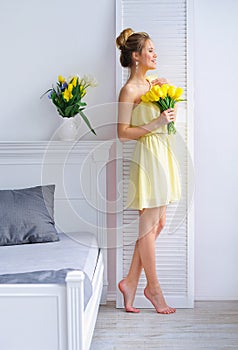 Morning light and woman with yellow tulips