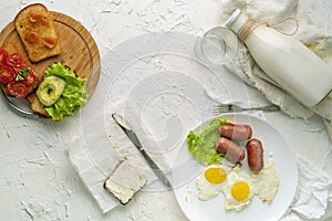 morning meal concept, table with milk with eggs and nutritious sandwichs