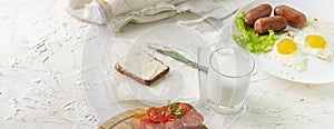 morning meal concept, table with milk with eggs and nutritious sandwichs