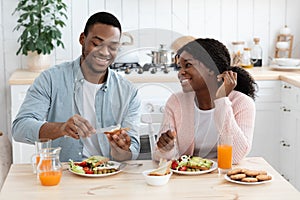 Morning Meal. Portrait Of Cheerful Black Couple Enjoying Tasty Breakfast In Kitchen