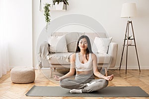 Morning Meditation. Asian Girl Practicing Yoga at Home