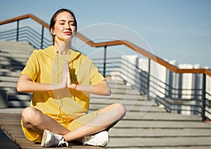 Morning meditation in a city park. Woman in lotus position