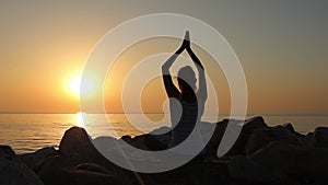 Morning meditation, woman practices yoga on the seashore, Shot on Canon EOS 5D Mark IV in Slow Motion