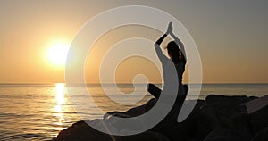 Morning meditation, woman practices yoga on the seashore, Shot on Canon EOS 5D Mark IV in Slow Motion