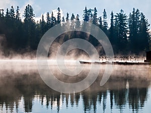 Morning mist above Strbske pleso mountain lake