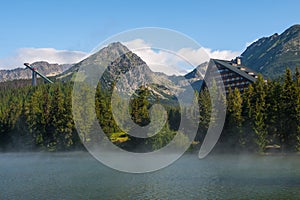 Morning mist above Strbske pleso mountain lake