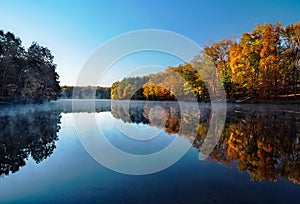 Morning mist and fall colors at Rocky Gorge Reservoir in Howard County, Maryland photo